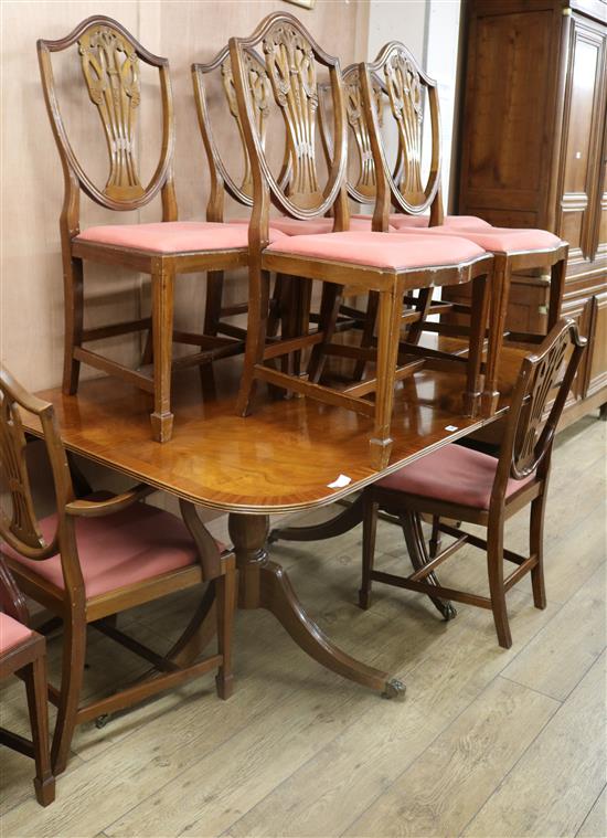 A set of eight Hepplewhite style mahogany dining chairs and a Regency style mahogany two pillar dining table W.168cm